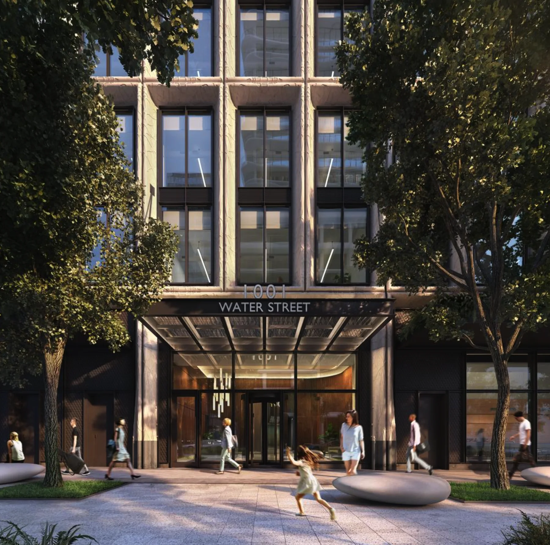 Rendering of the 1001 Water Street entrance: a glass canopy under a stone-framed facade, trees and stone benches on the sidewalk