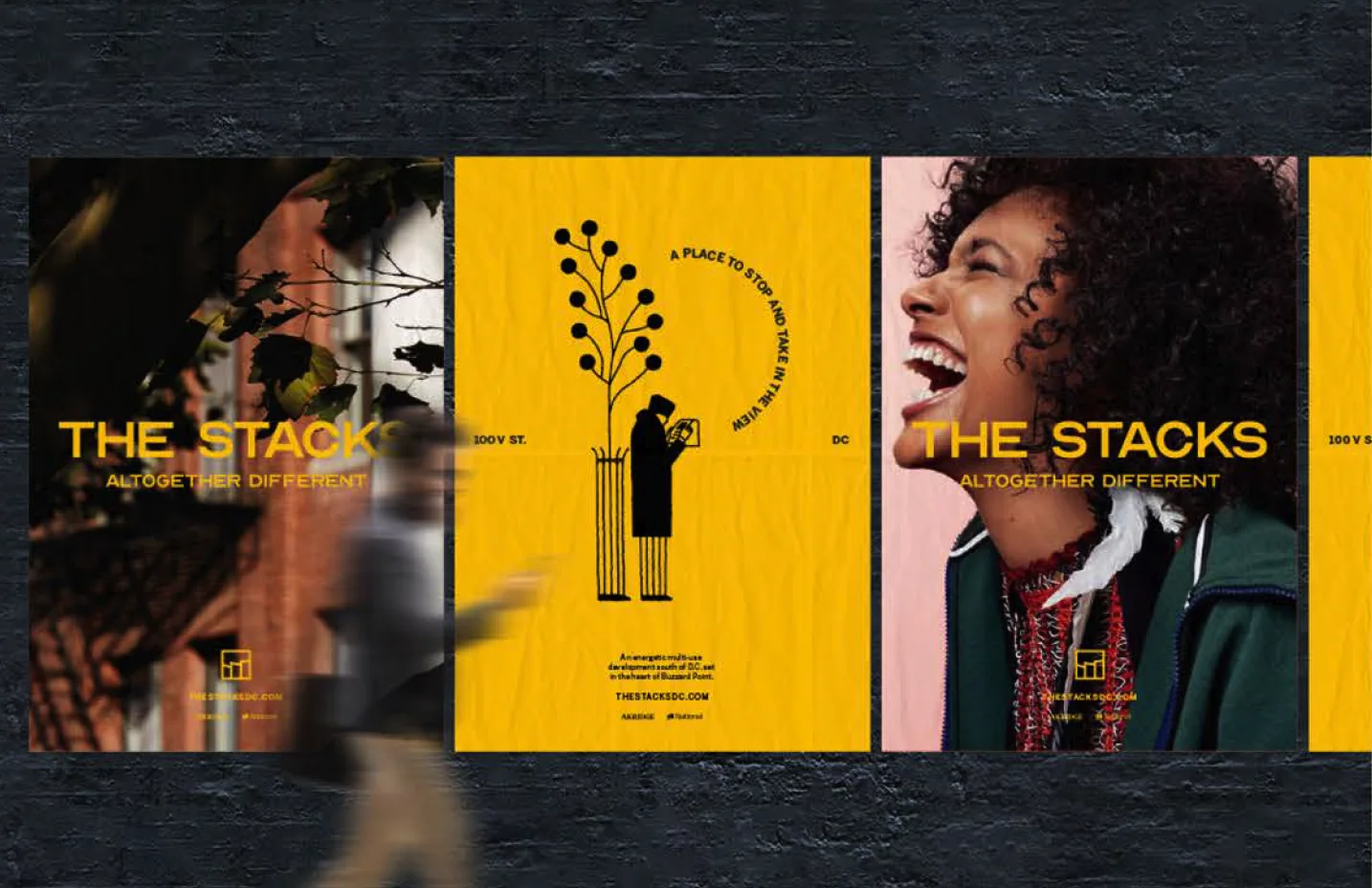 Three Stacks posters on a brick wall: a leafy facade, a yellow illustration of a reader beside a tree, and a laughing woman