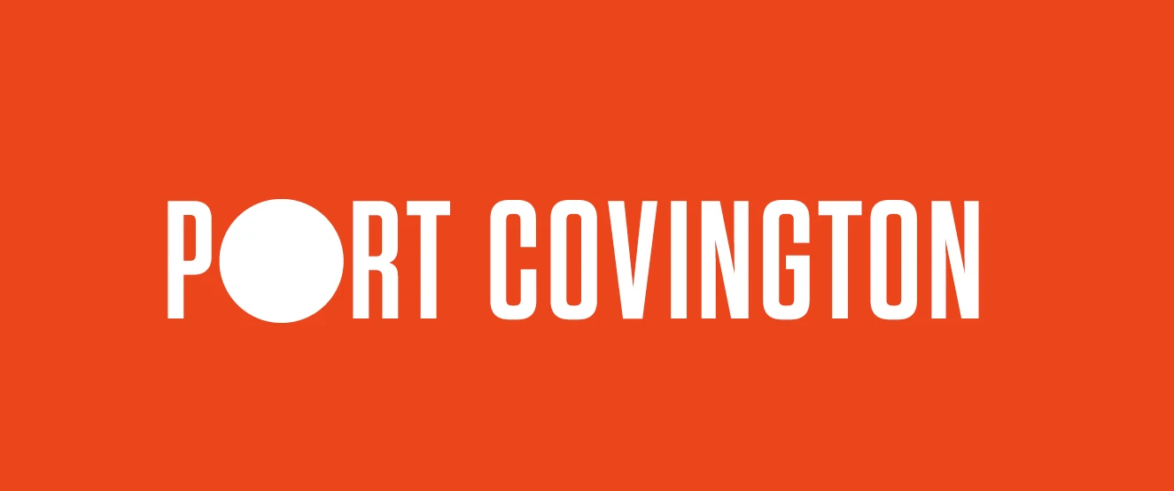 Port Covington wordmark: tall condensed white capitals on orange, the O a solid white disc
